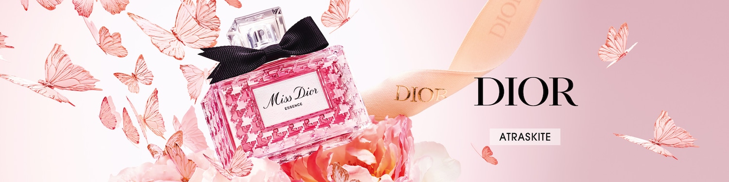 Švelnus rožinis fonas su skraidančiais drugeliais, Dior juosta ir Miss Dior Essence kvepalų buteliukas su juodu kaspinu ant viršaus, elegantiškam ir moteriškam įvaizdžiui.