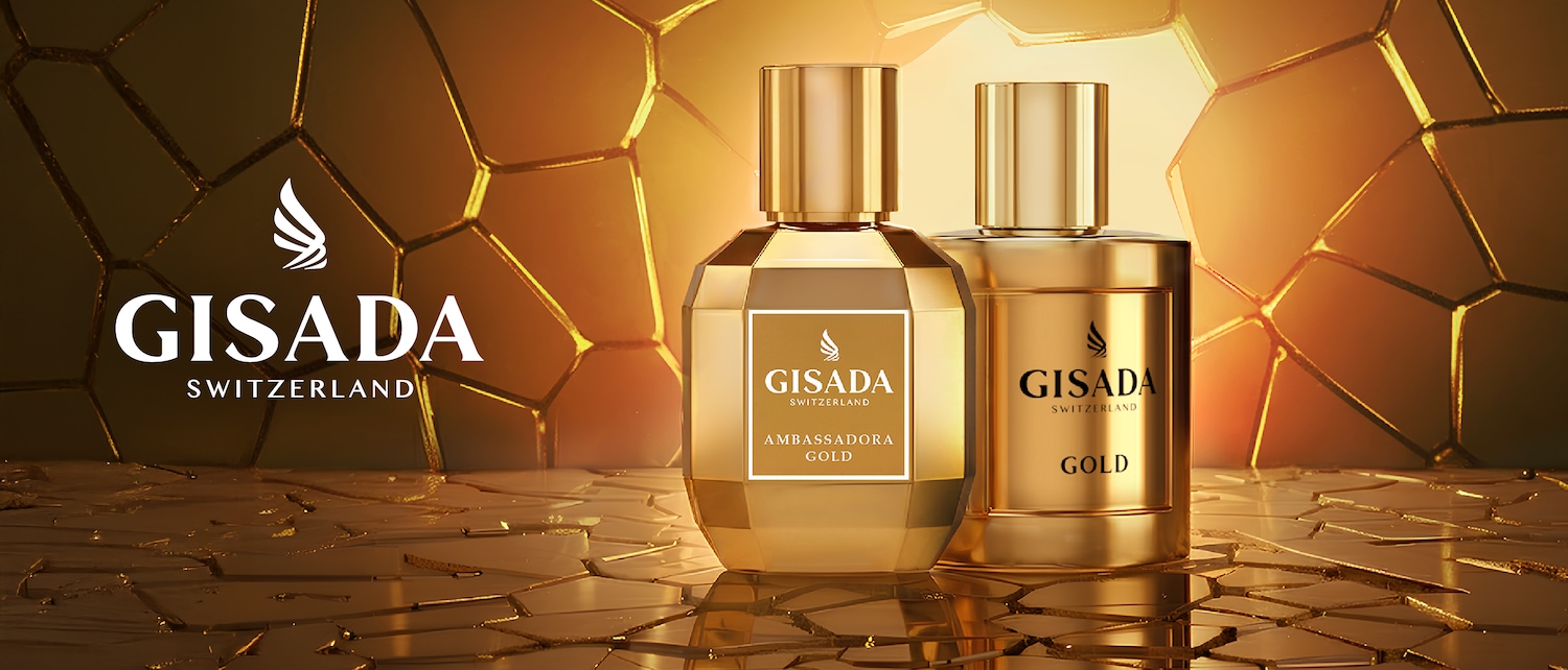 Du auksiniai „Gisada Switzerland“ kvepalų buteliukai ant auksinio fono, vienas – „Ambassadora Gold“, kitas – „Gold“.